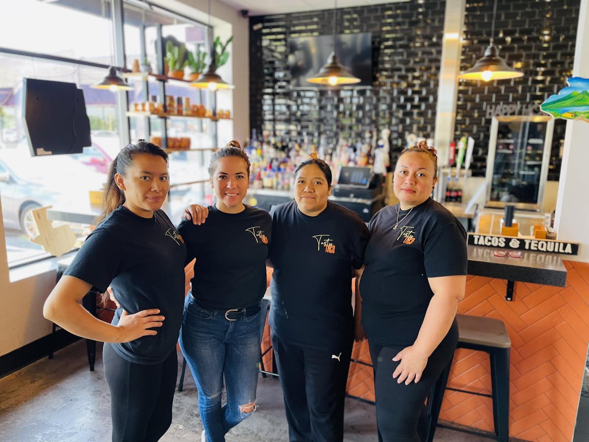 four mrs. taco employees standing in the restaurant